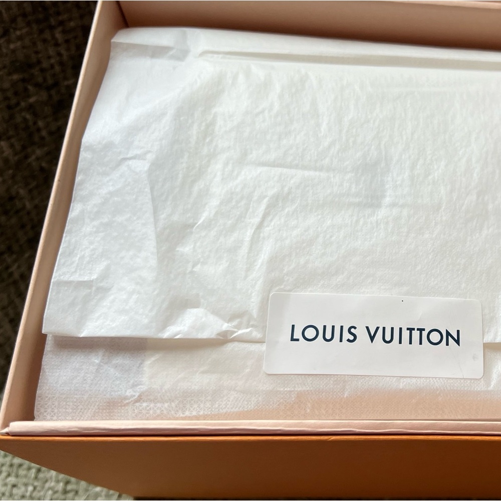 LV candle. Never lit but did sit outside the box. Includes all original package